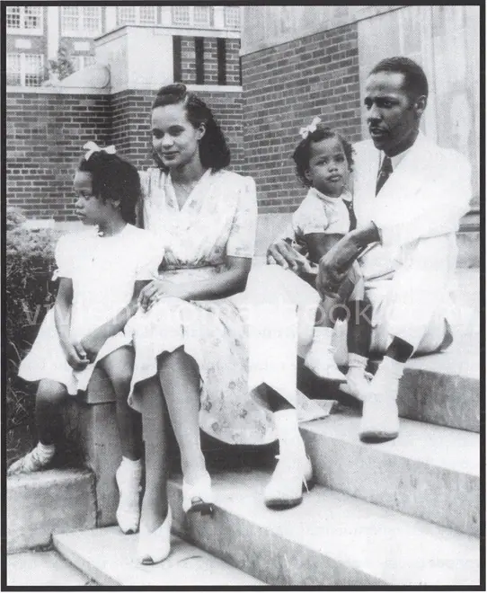 Vivien Thomas sits with his wife, Clara Thomas, and their two daughters, Olga and Theodosia Thomas, in Nashville in 1941